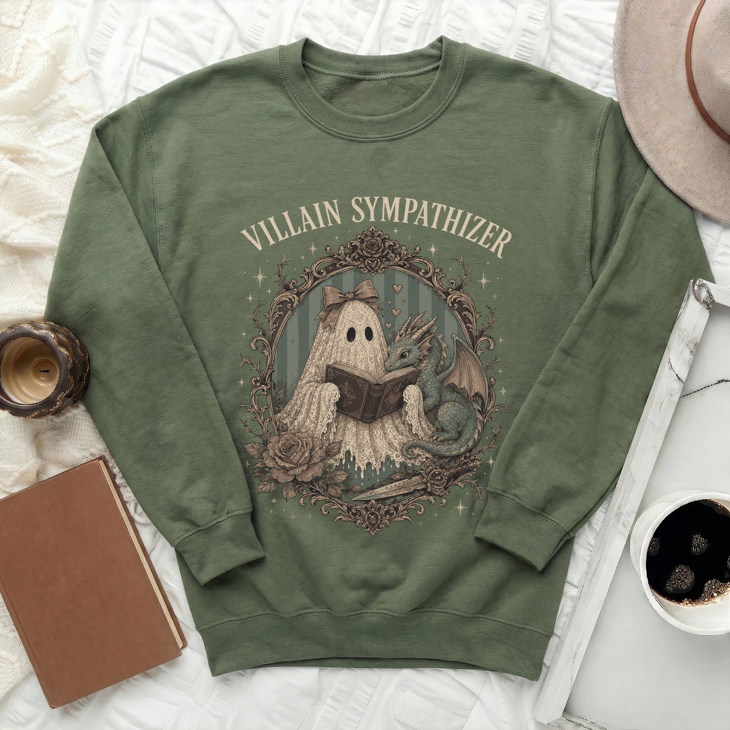 Green sweatshirt with vintage style graphic of a ghost reading to a dragon.