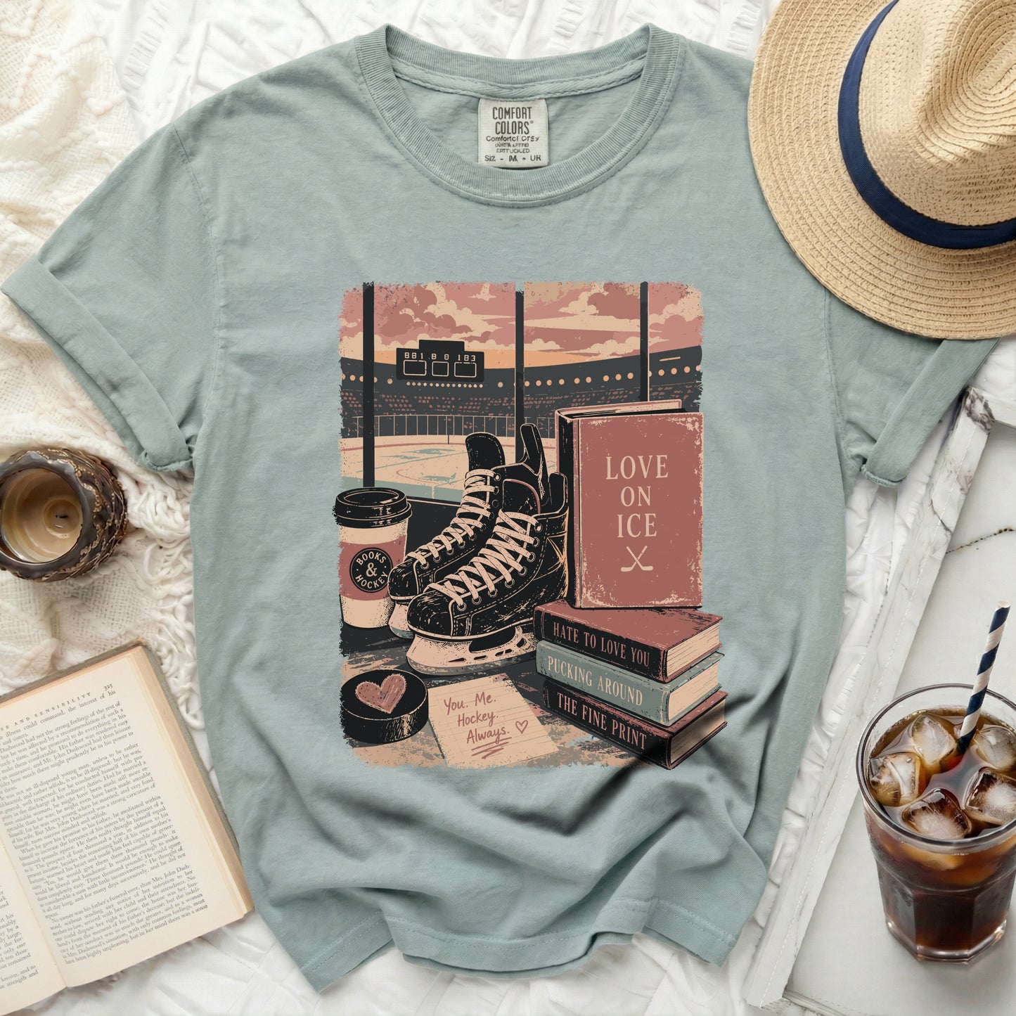 T-shirt with books, ice skates, hockey puck, and text.