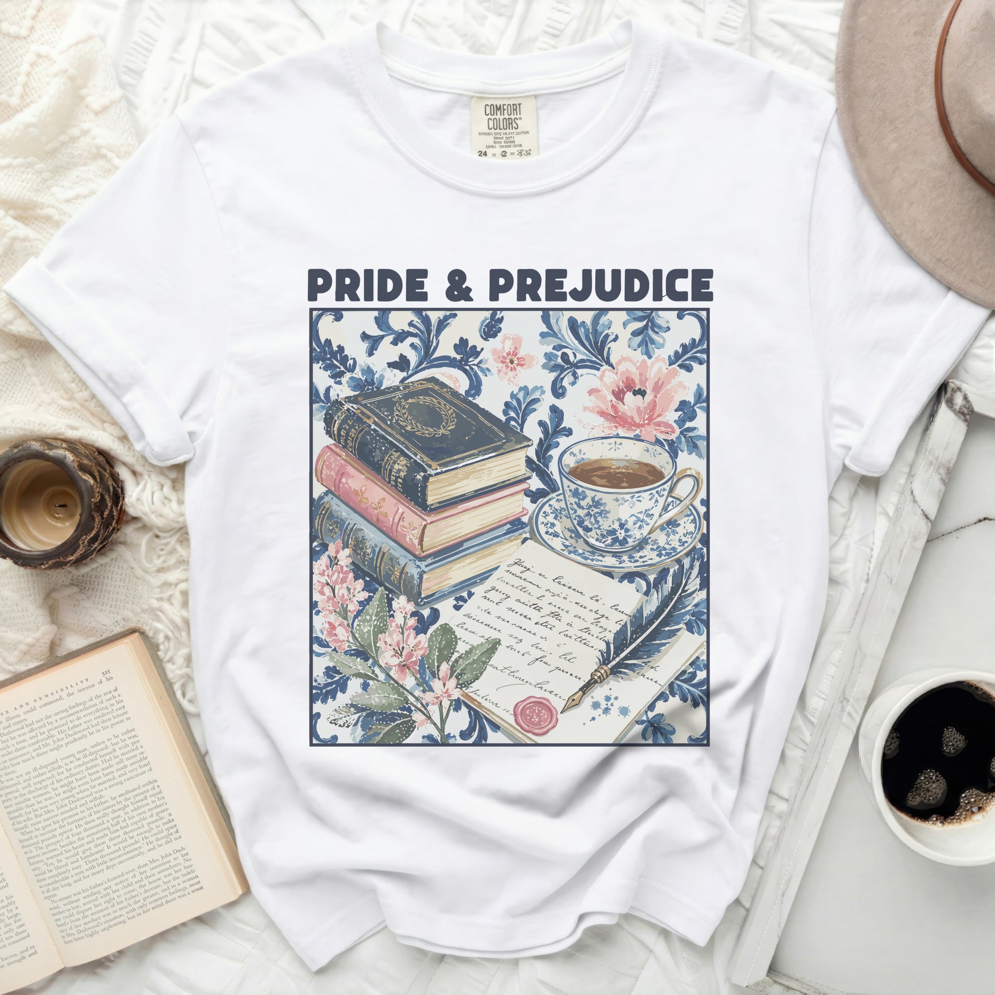 White t-shirt with "Pride & Prejudice" featuring stacked books and tea set graphic.
