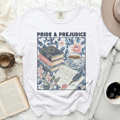 White t-shirt with "Pride & Prejudice" featuring stacked books and tea set graphic.