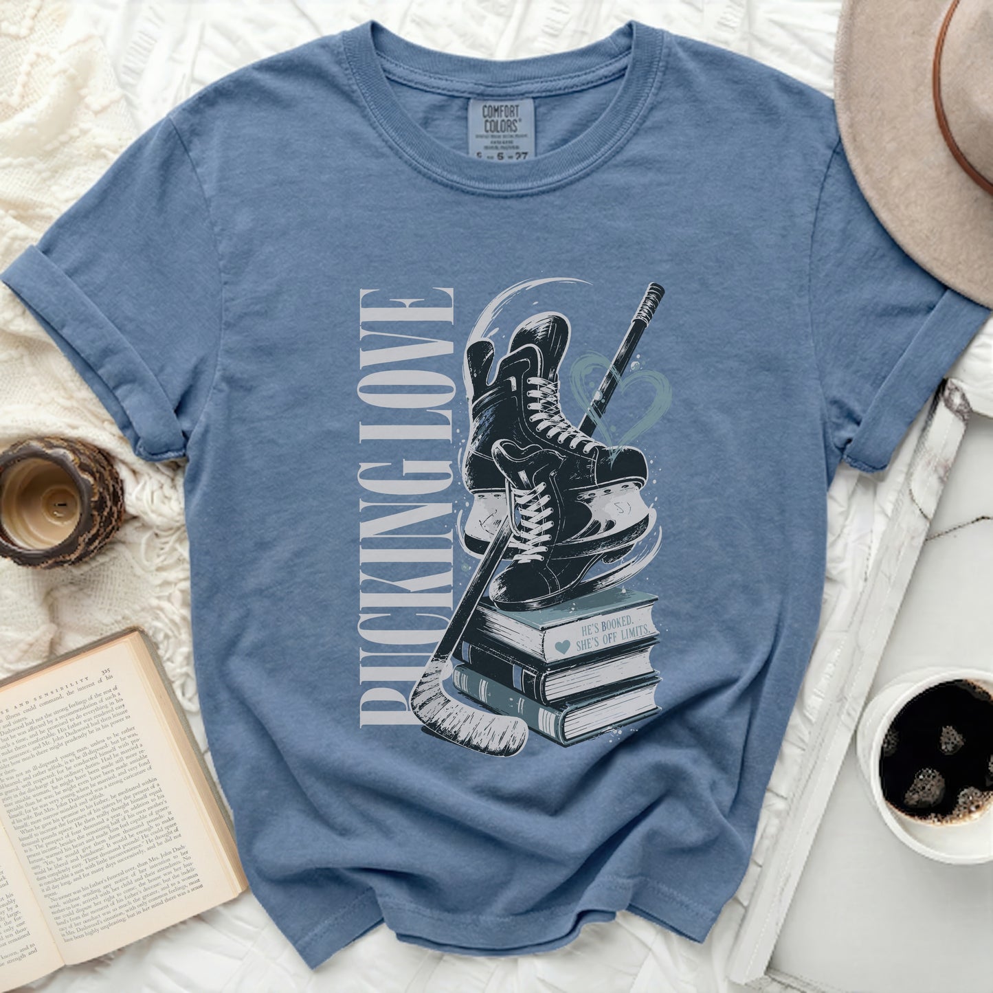 Blue t-shirt with "PUCKING LOVE" and hockey skates on books.