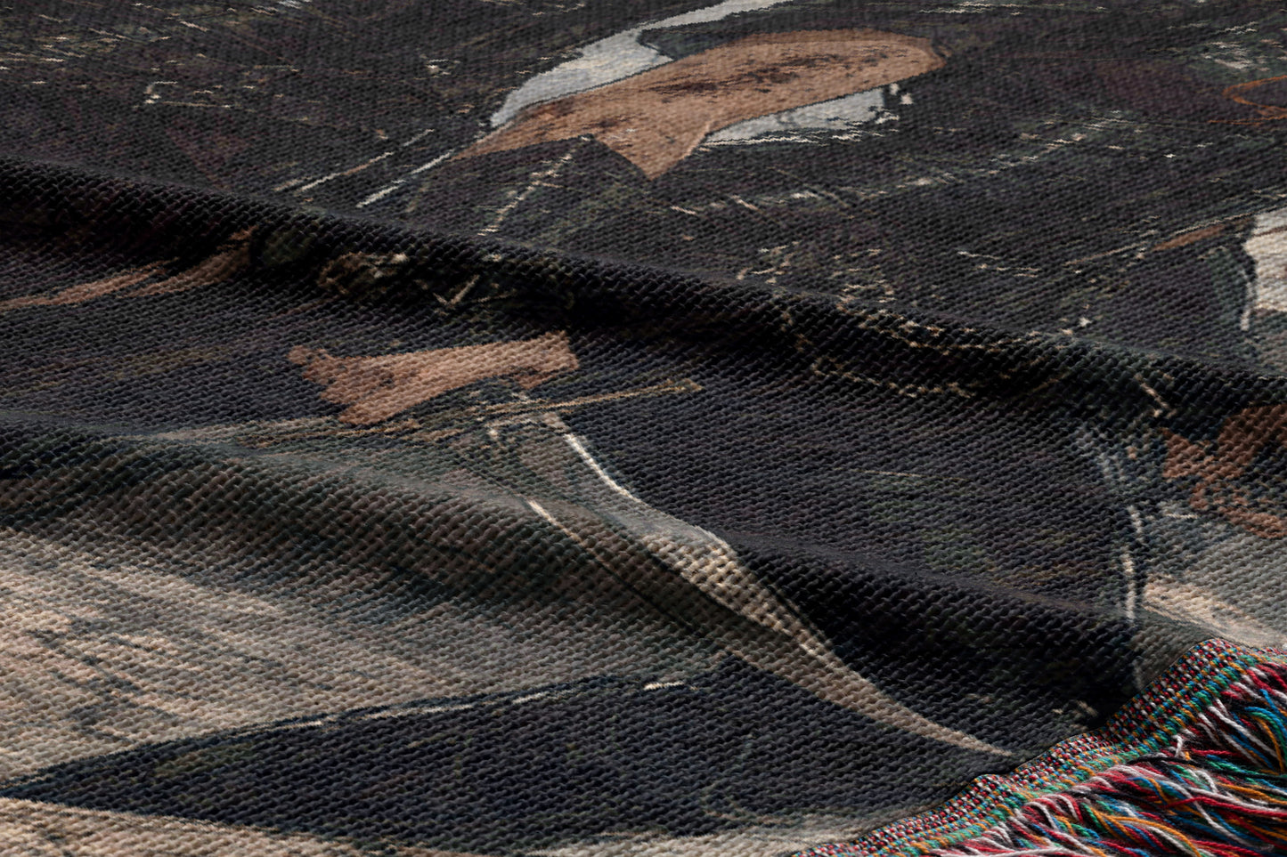 The image is a close-up of a fabric with a printed design, featuring a person's face and a sword.