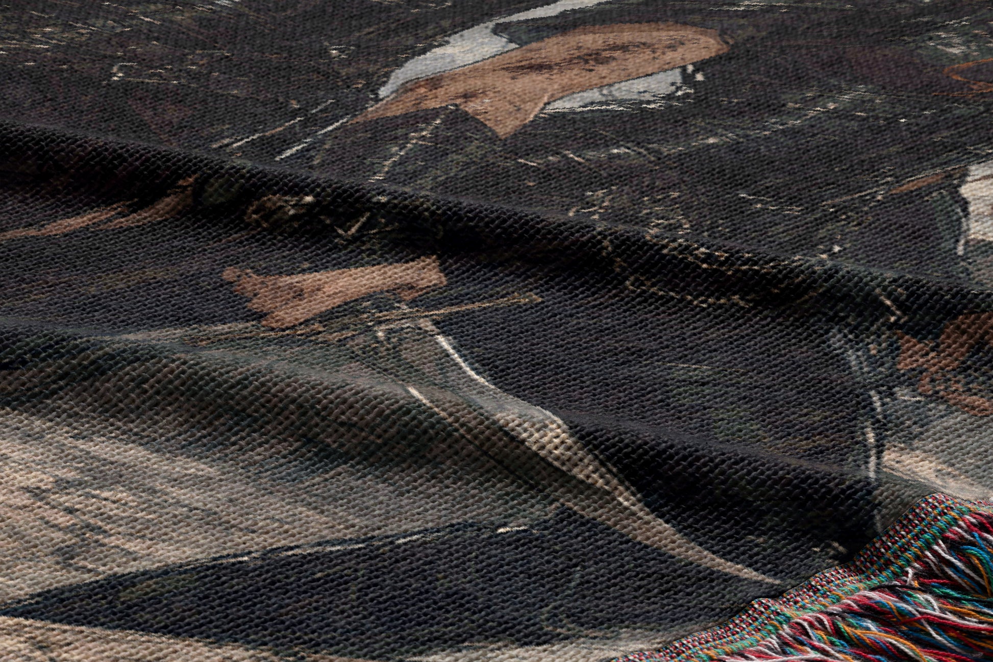 The image is a close-up of a fabric with a printed design, featuring a person's face and a sword.
