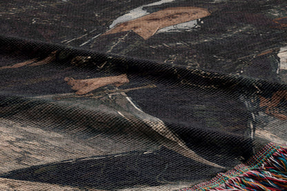 The image is a close-up of a fabric with a printed design, featuring a person's face and a sword.