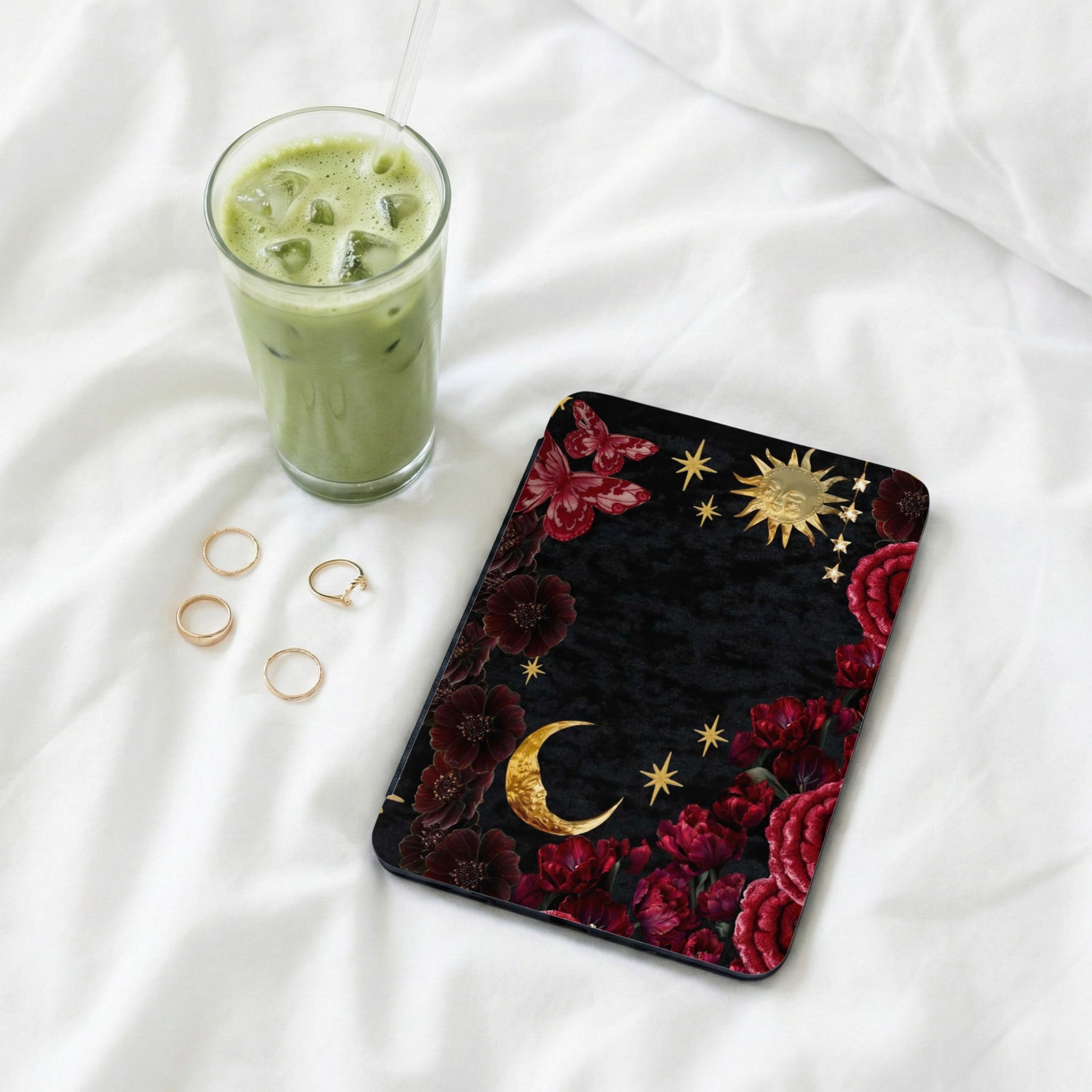 Black celestial phone case with moons, stars, butterflies, and floral patterns.