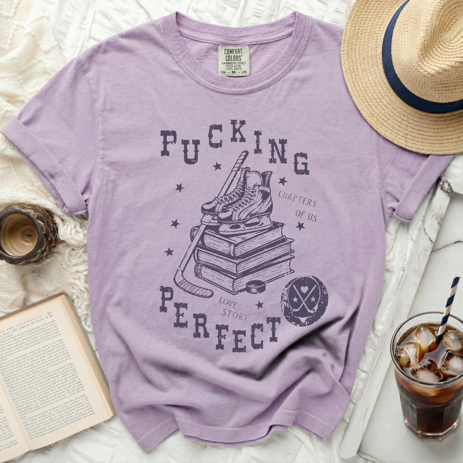 Purple t-shirt with hockey skates, puck, book, and text.