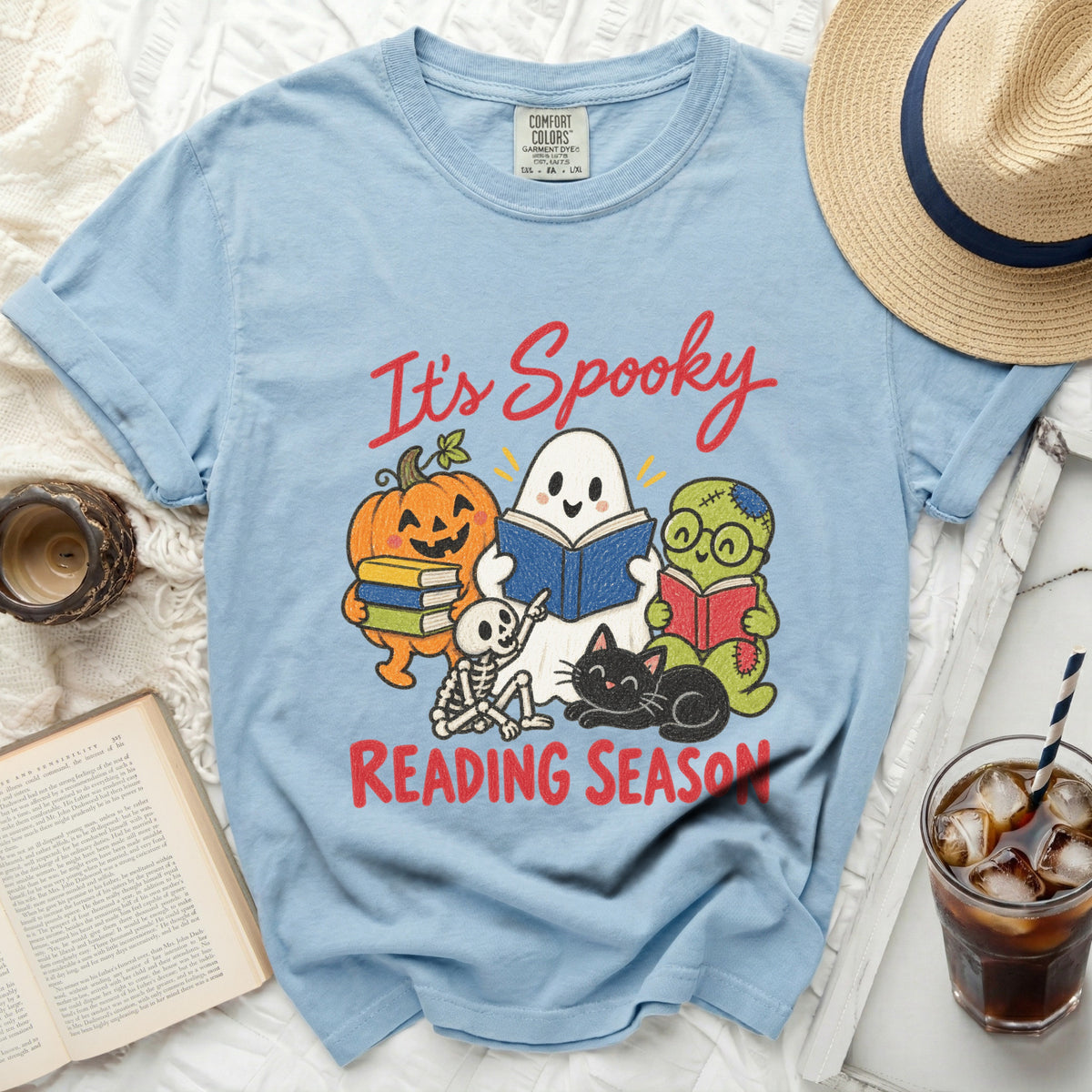 Light blue t-shirt with "It's Spooky Reading Season" graphic and Halloween characters.