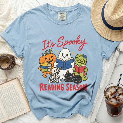 Light blue t-shirt with "It's Spooky Reading Season" graphic and Halloween characters.