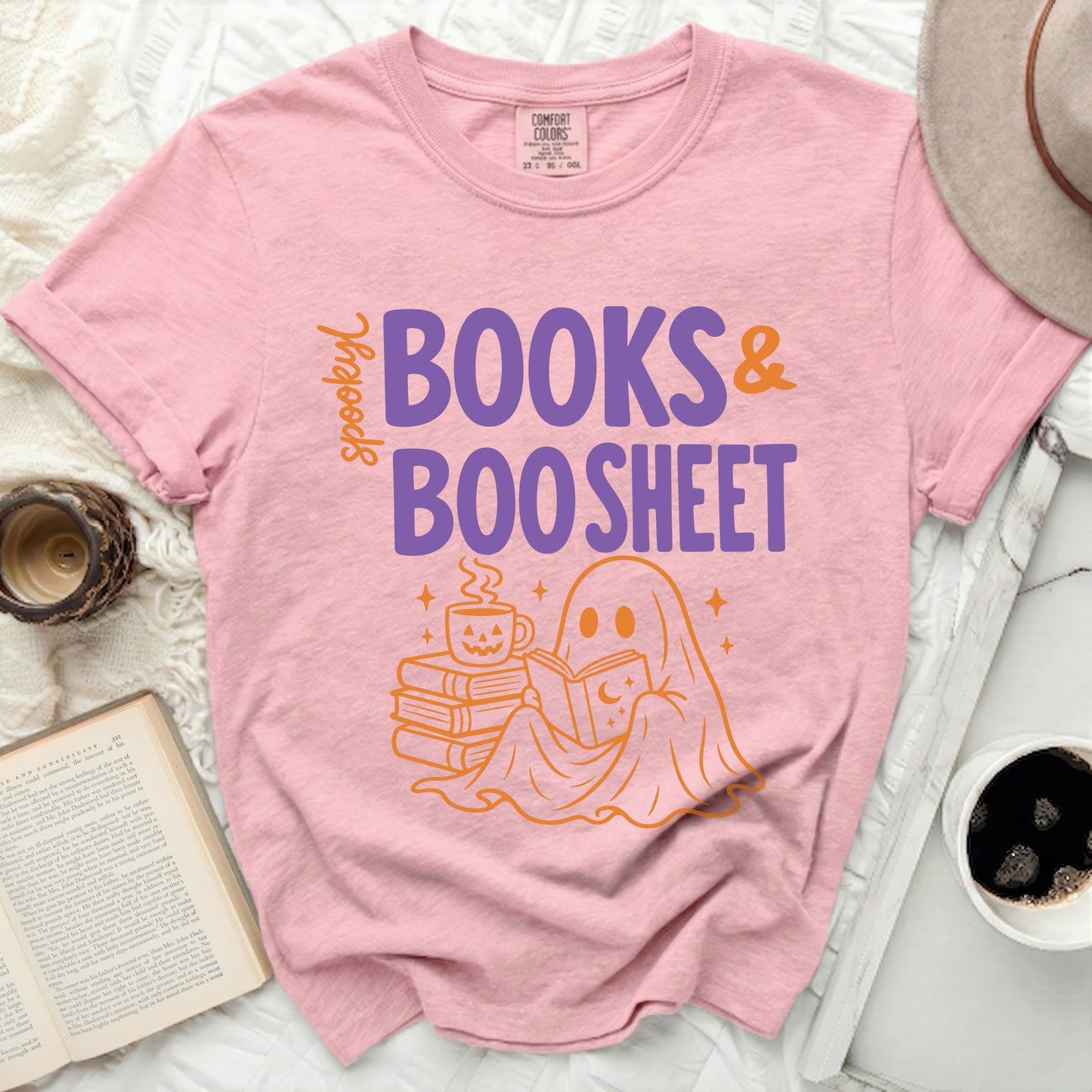 Pink t-shirt with ghost reading books and "Spooky Books & Boo Sheet" text.
