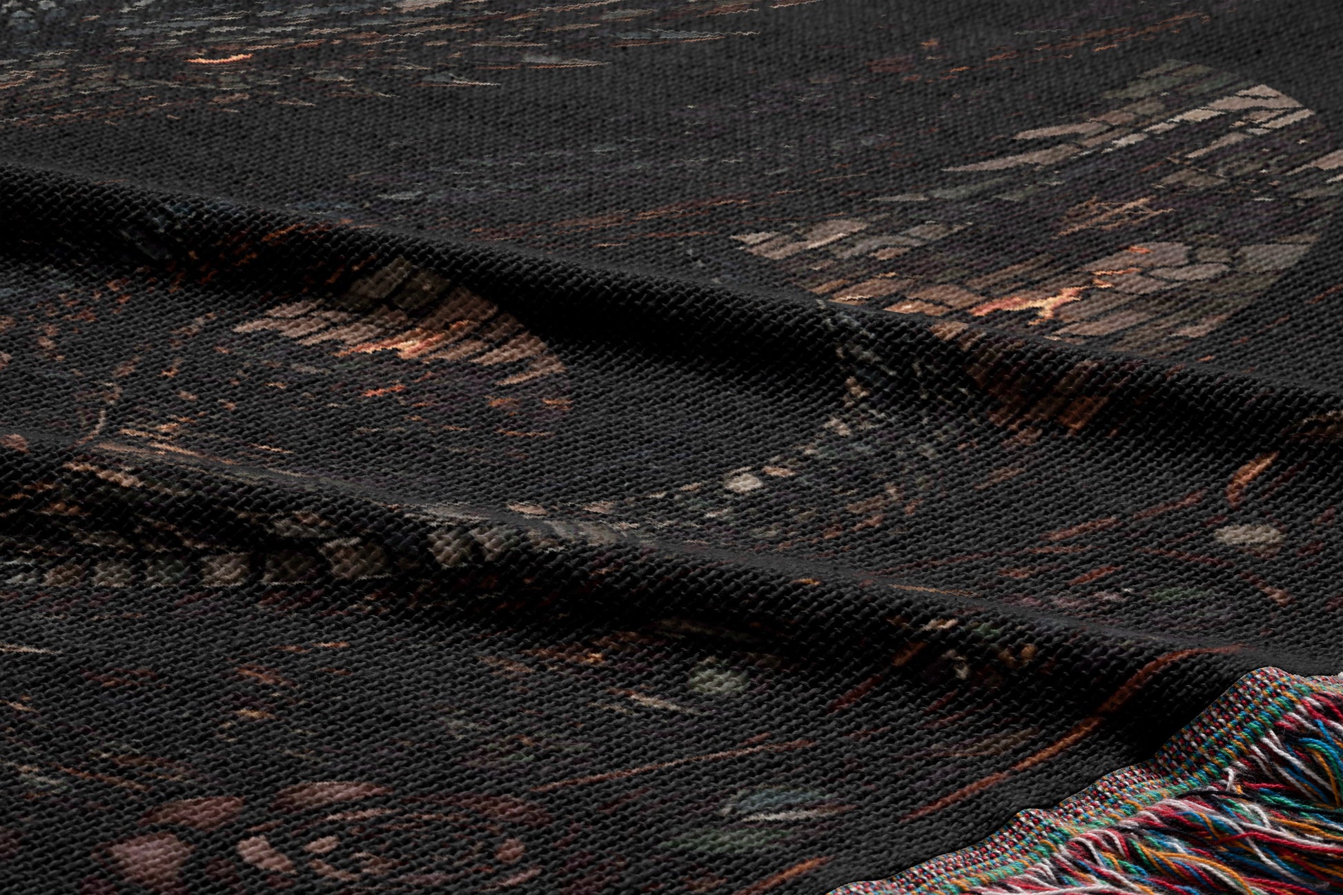 a close-up view of a dark-colored fabric with a patterned design, including a mix of geometric shapes and organic elements.