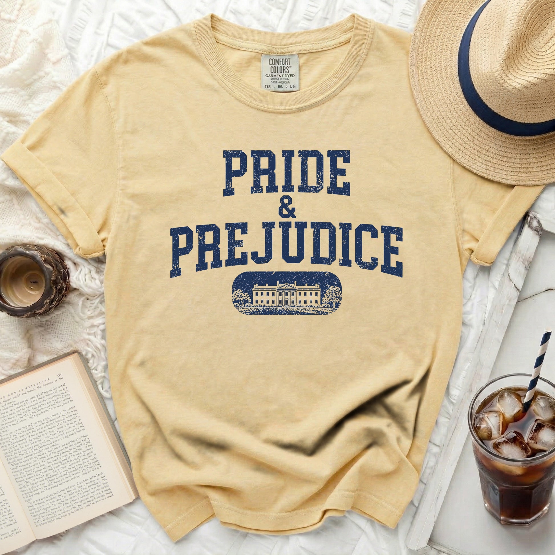 Yellow t-shirt with "PRIDE & PREJUDICE" and a building graphic.