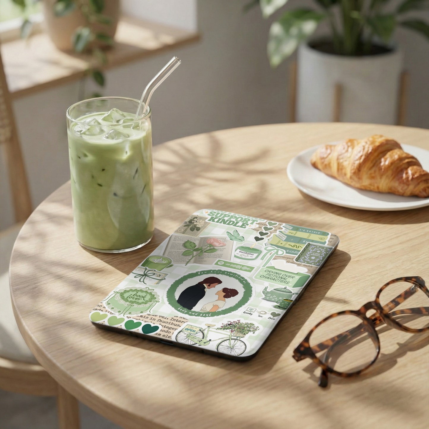 E-reader case with a collage of green bookish and romantic stickers.