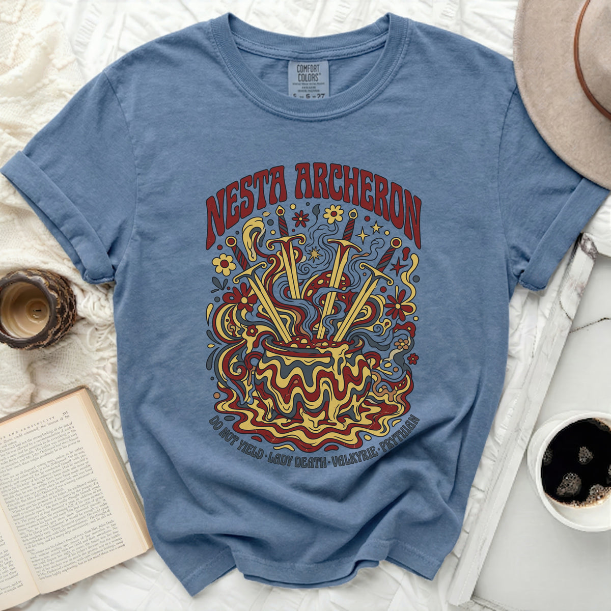 Blue t-shirt with "Nesta Archeron Do Not Yield Lady Death Valkyrie Prythian" graphic.