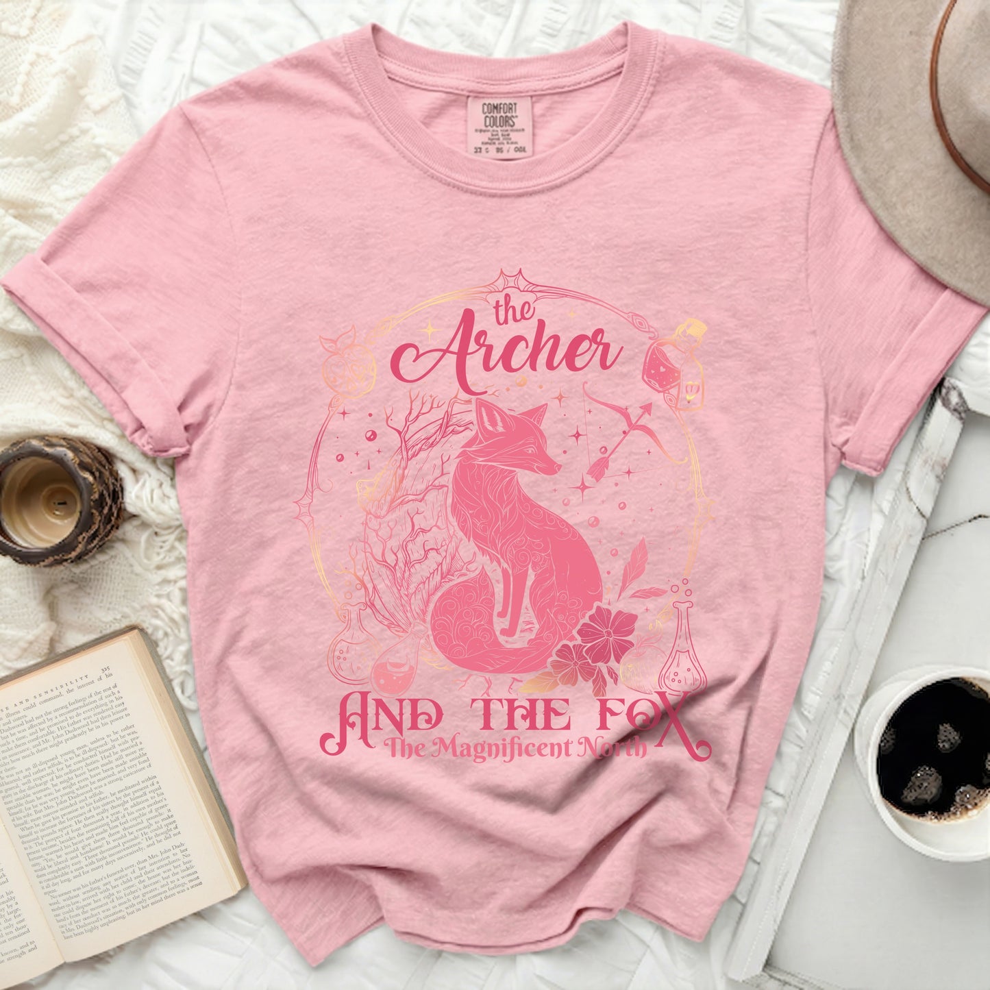 Pink t-shirt with "The Archer and the Fox, The Magnificent North" text.