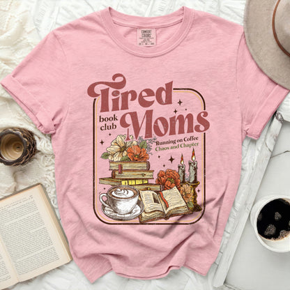 Tired Moms book club shirt with coffee, books, and candles.