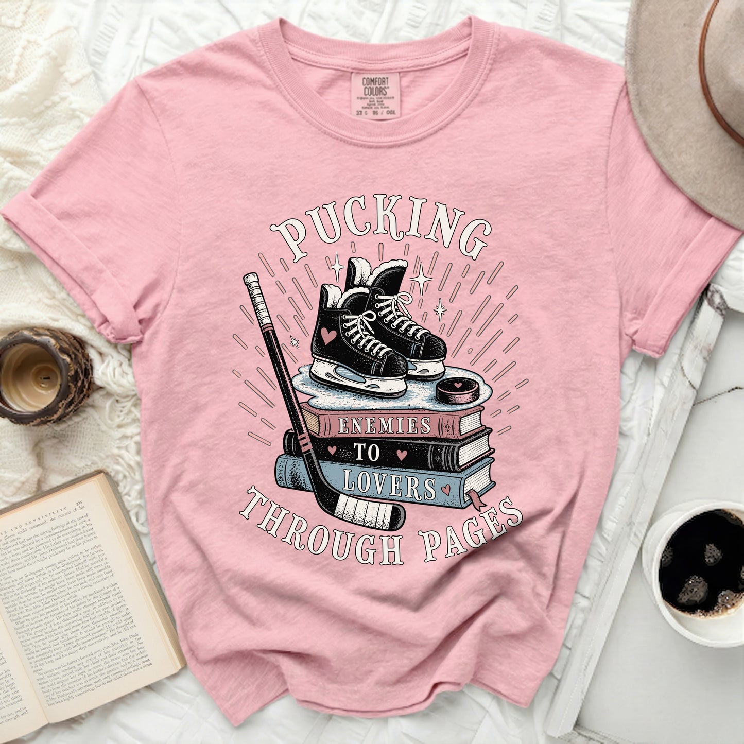 Pink t-shirt with roller skates and books graphic and text.