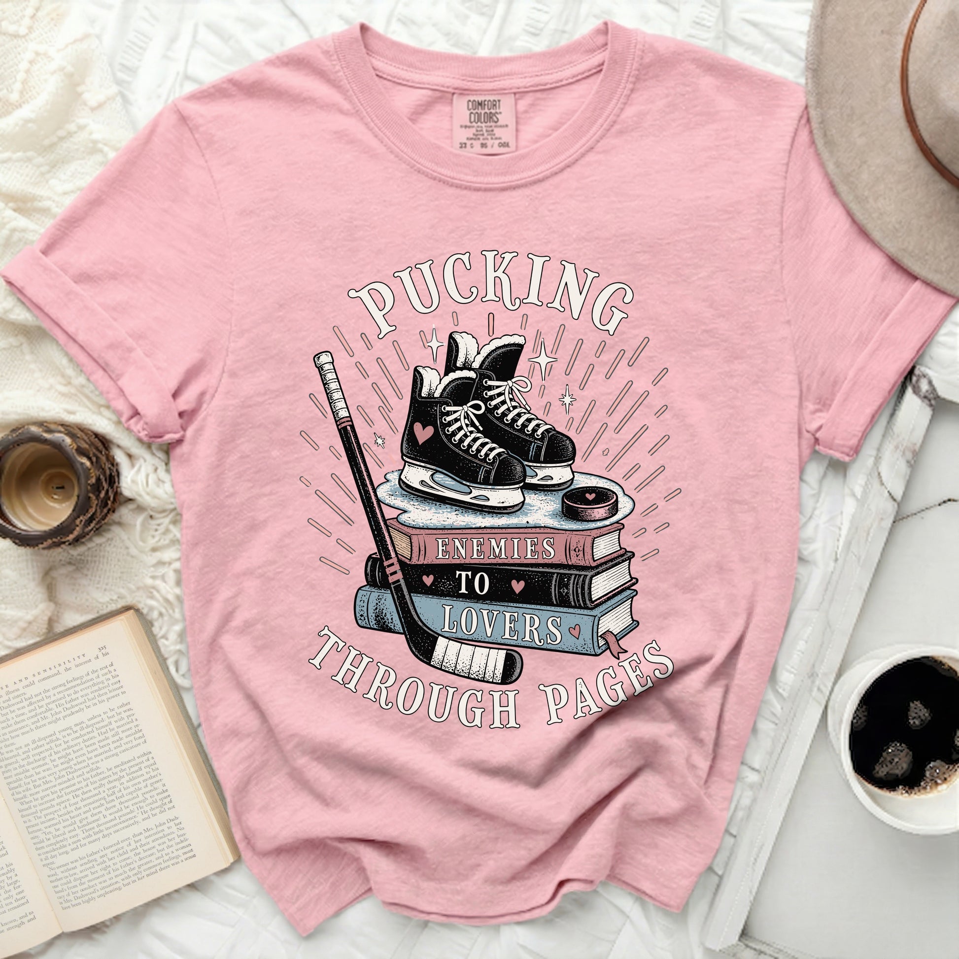 Pink t-shirt with roller skates and books graphic and text.