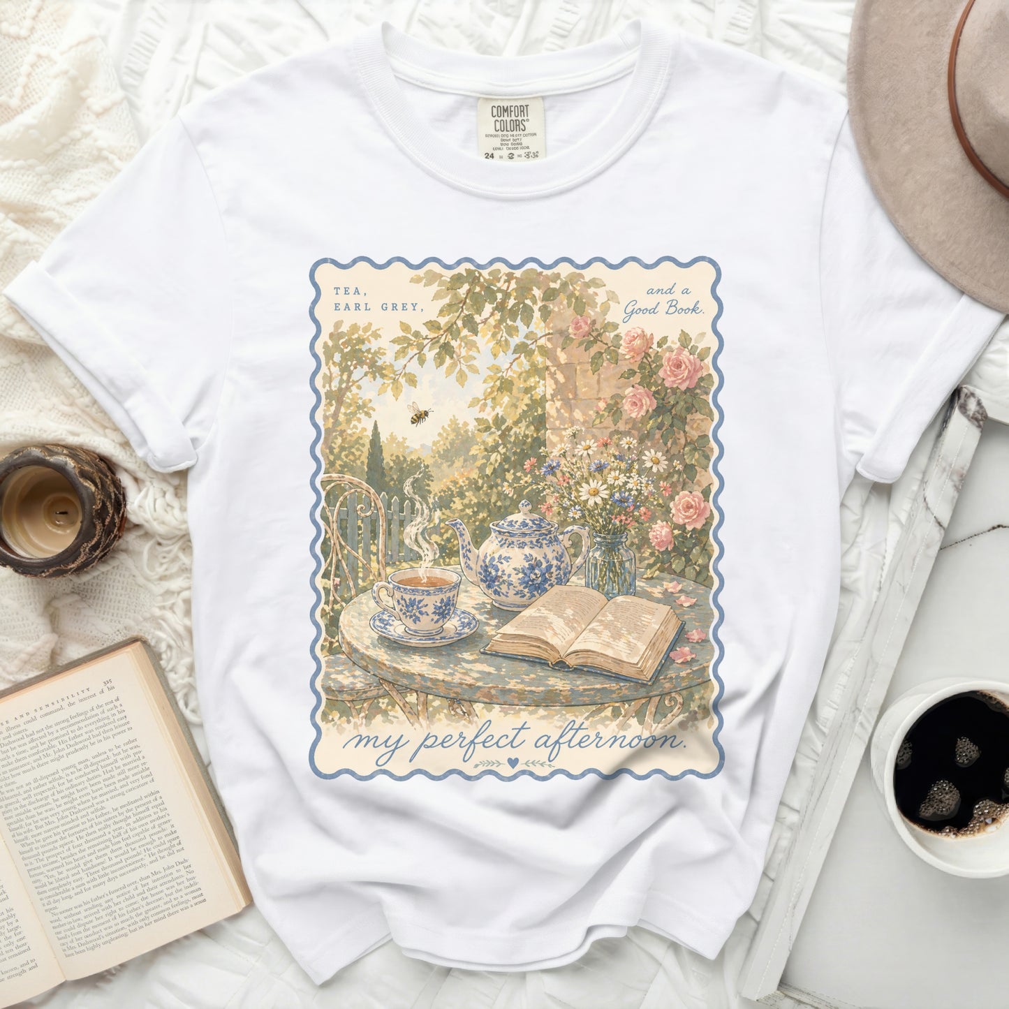 White t-shirt with "Tea, Earl Grey, and a Good Book" floral illustration.