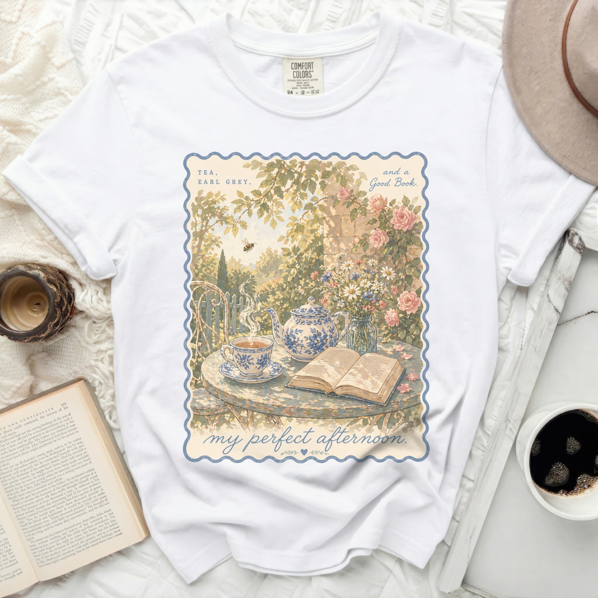 White t-shirt with "Tea, Earl Grey, and a Good Book" floral illustration.