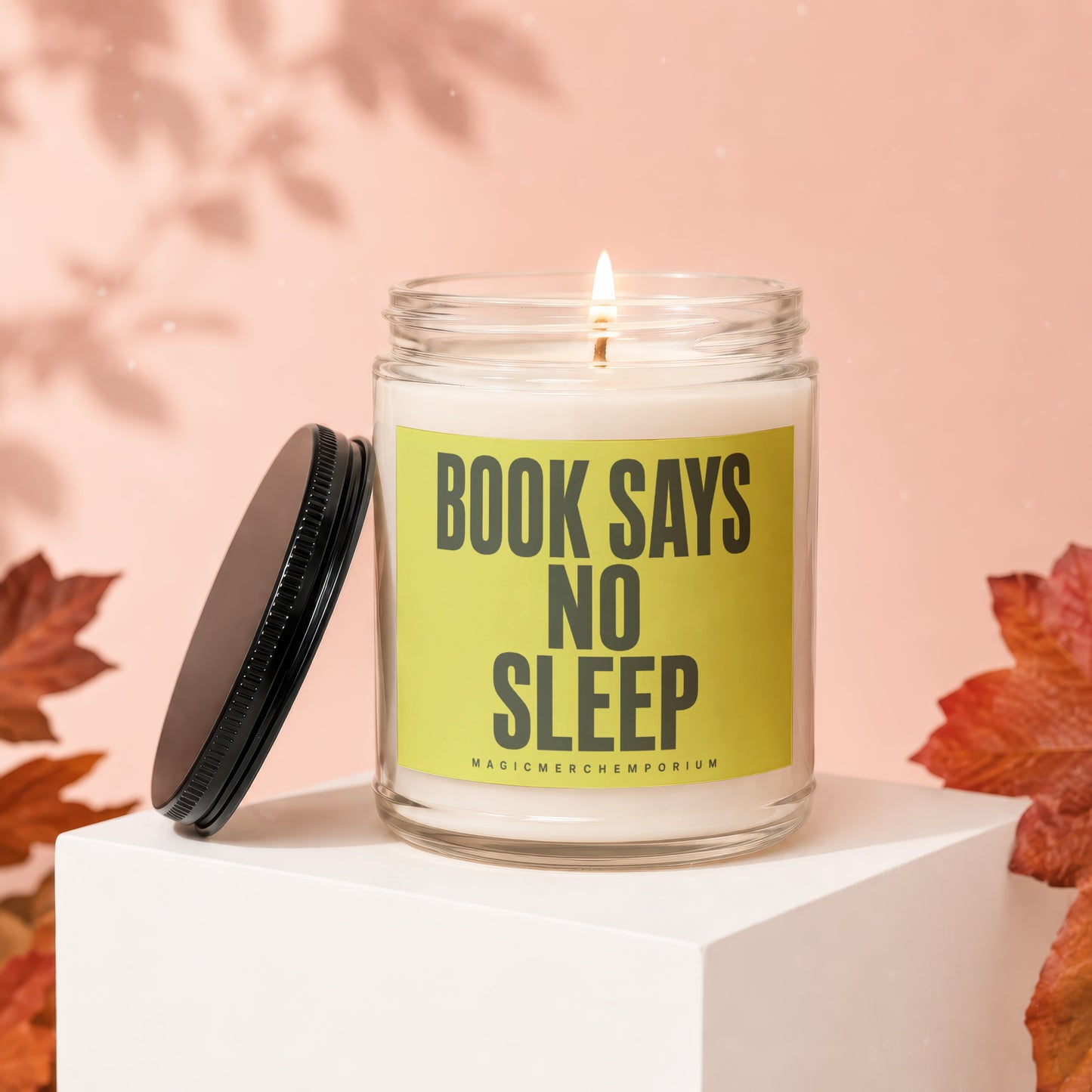 Jar candle with "BOOK SAYS NO SLEEP" text and a lid.