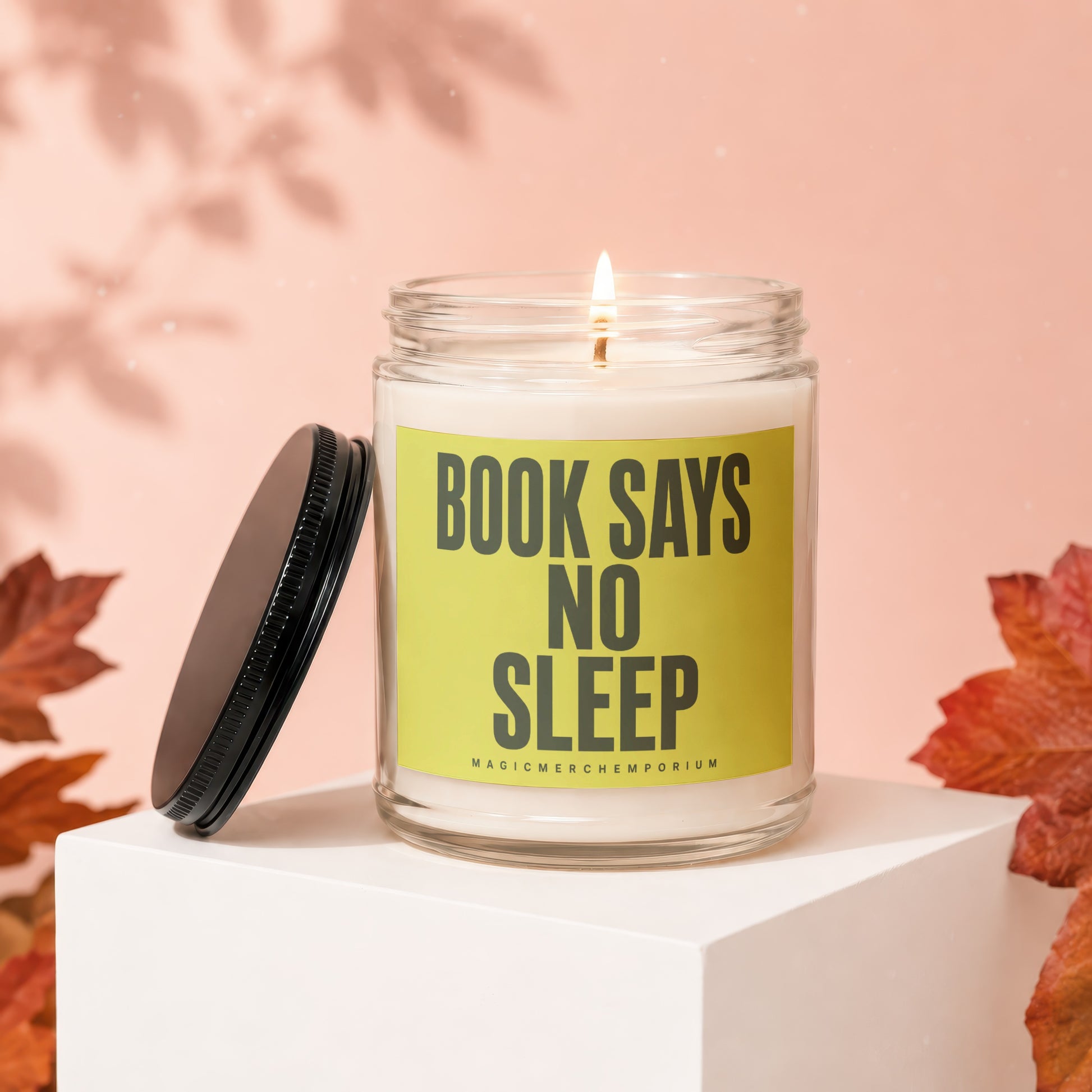Jar candle with "BOOK SAYS NO SLEEP" text and a lid.