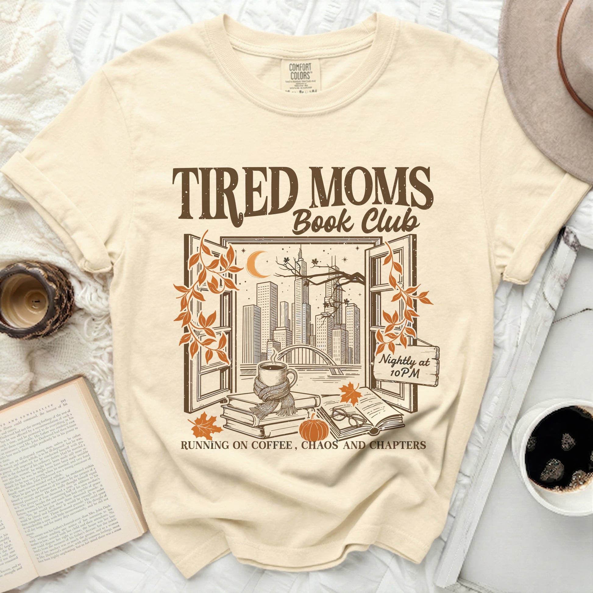 Tired Moms Book Club graphic tee with a city view, books, and text.