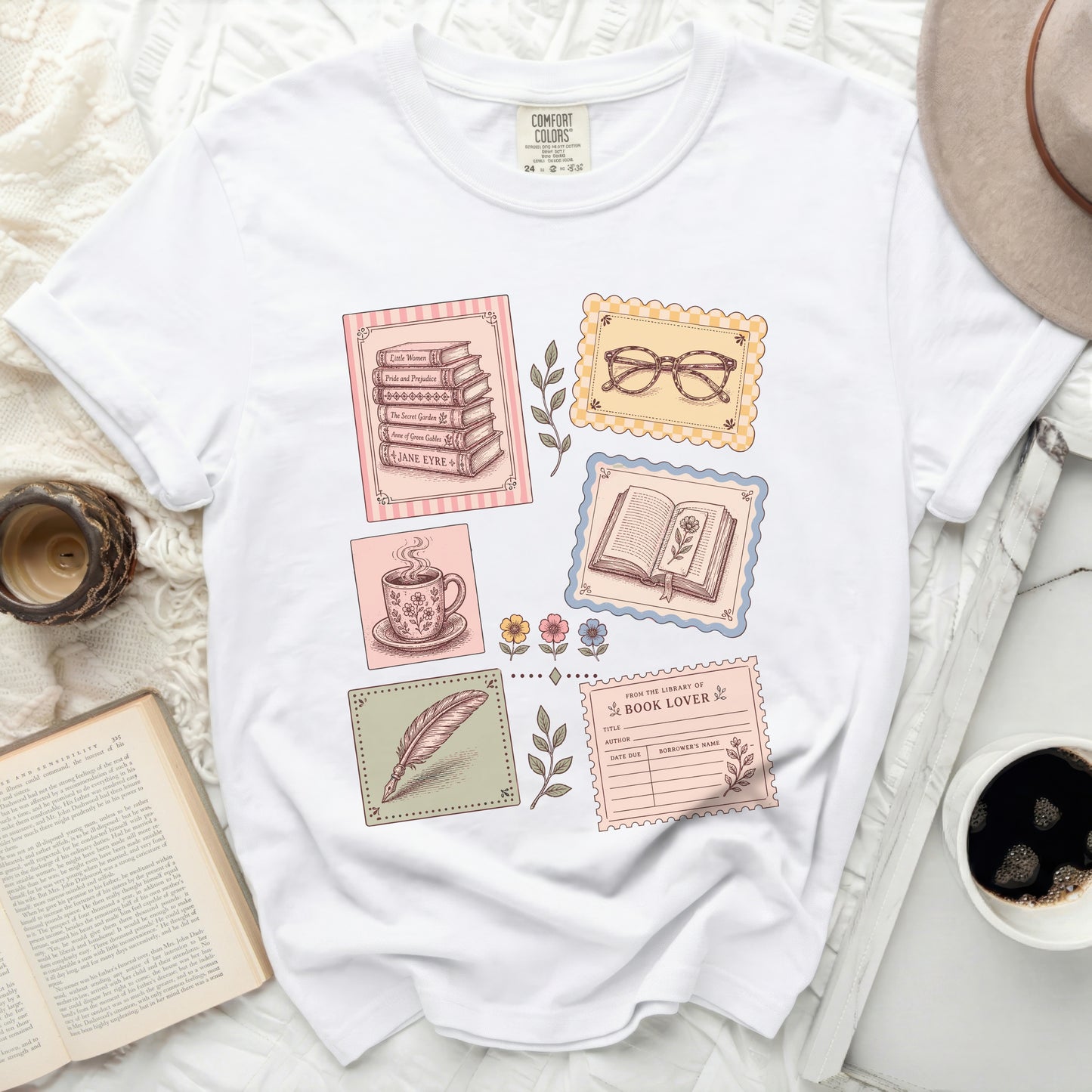 T-shirt with books, teacup, feather, and library card graphic.