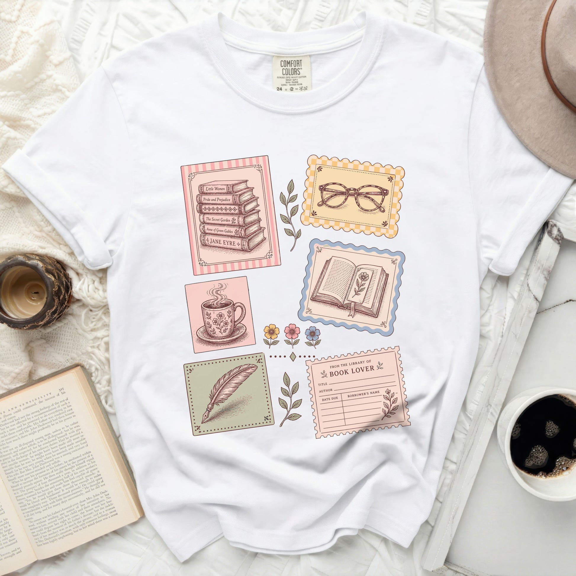 T-shirt with books, teacup, feather, and library card graphic.