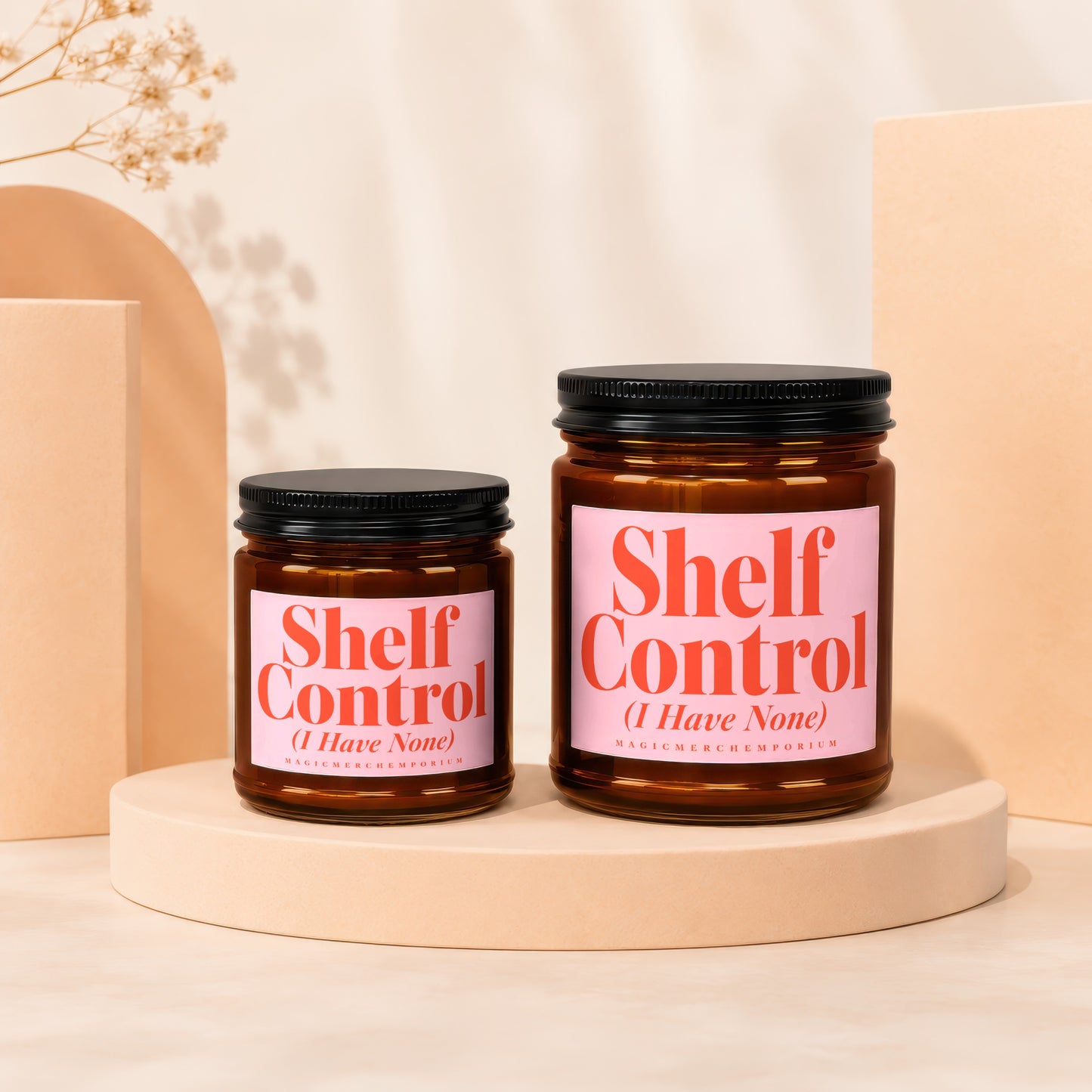 Two amber glass candles with pink labels reading "Shelf Control (I Have None)".