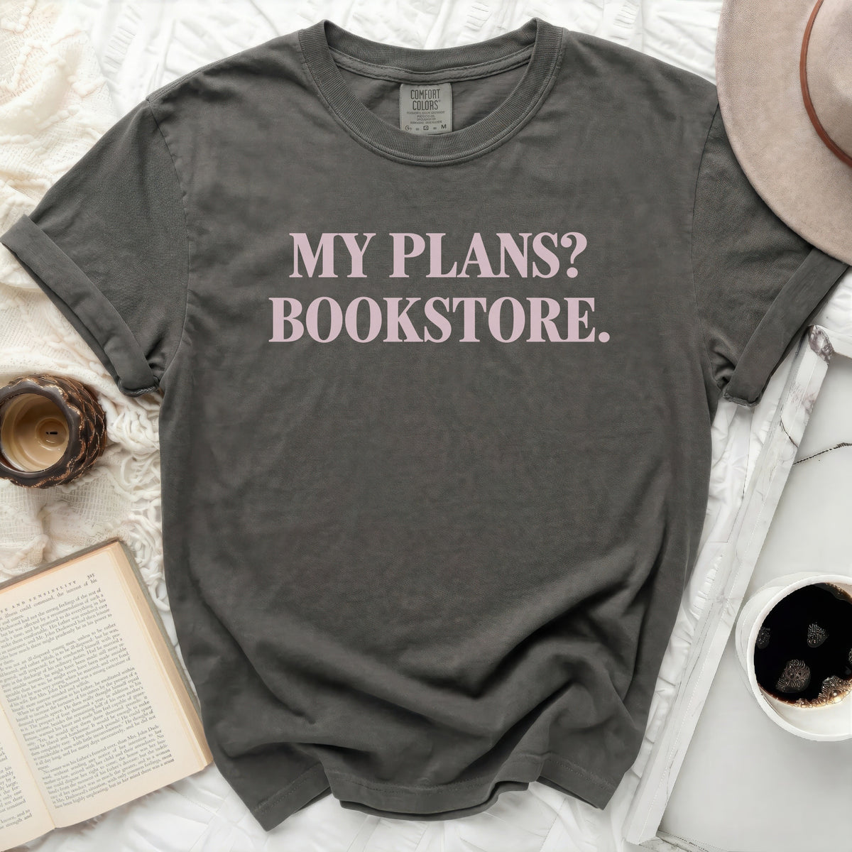 Dark grey Comfort Colors t-shirt with "MY PLANS? BOOKSTORE." in pink text.