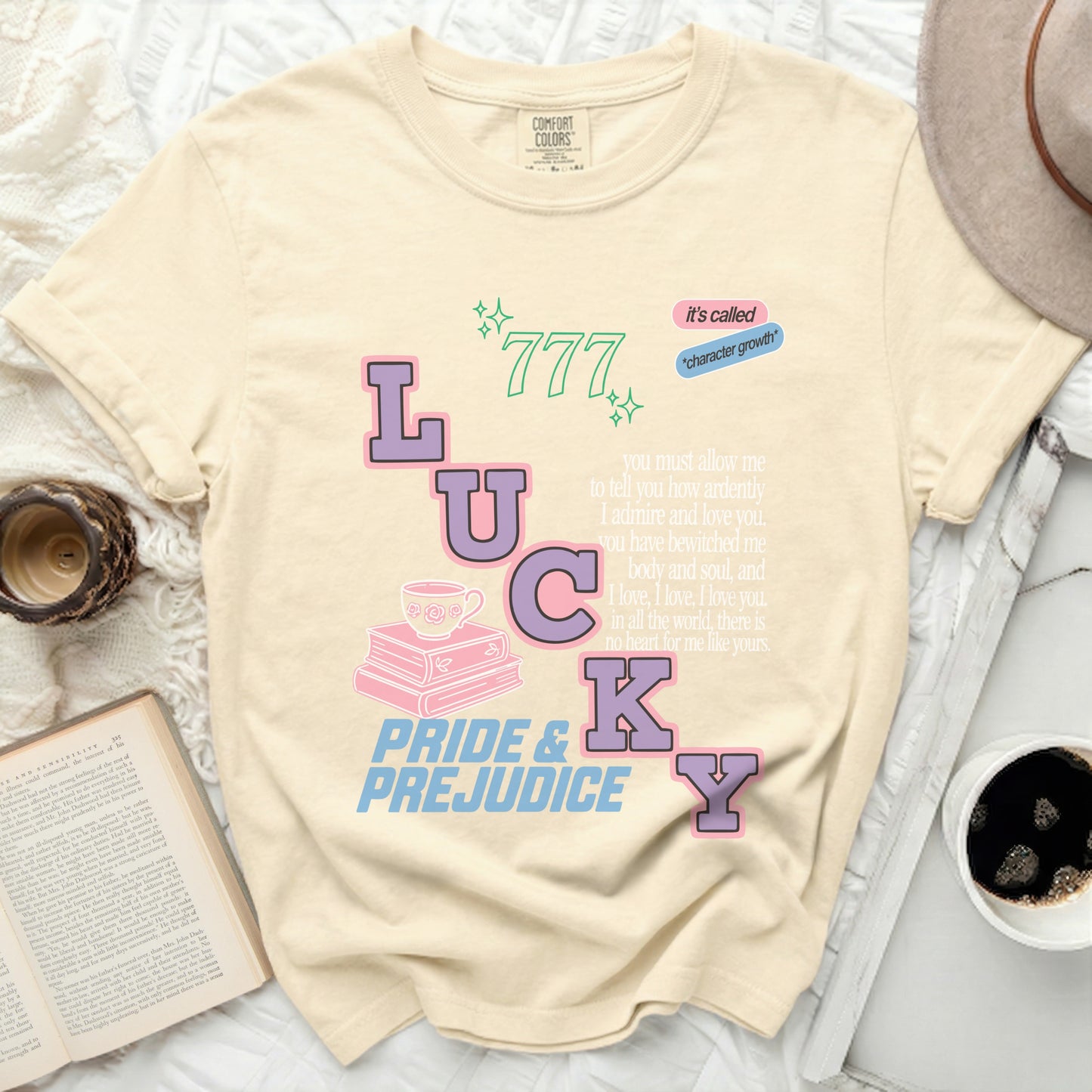Comfort Colors cream t-shirt with "LUCKY" and Pride and Prejudice text.