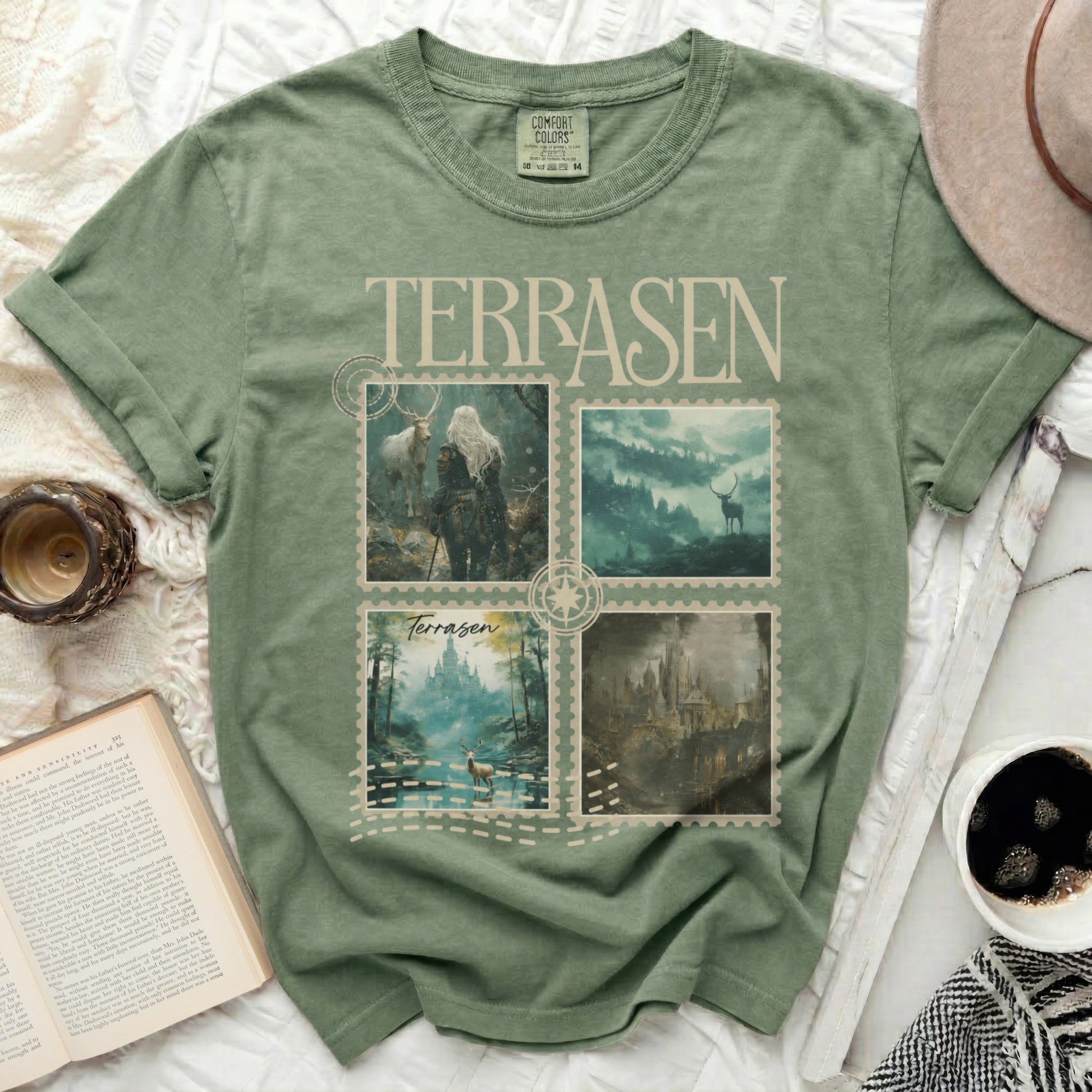 Green t-shirt with four postage stamp images of fantasy landscapes and text.