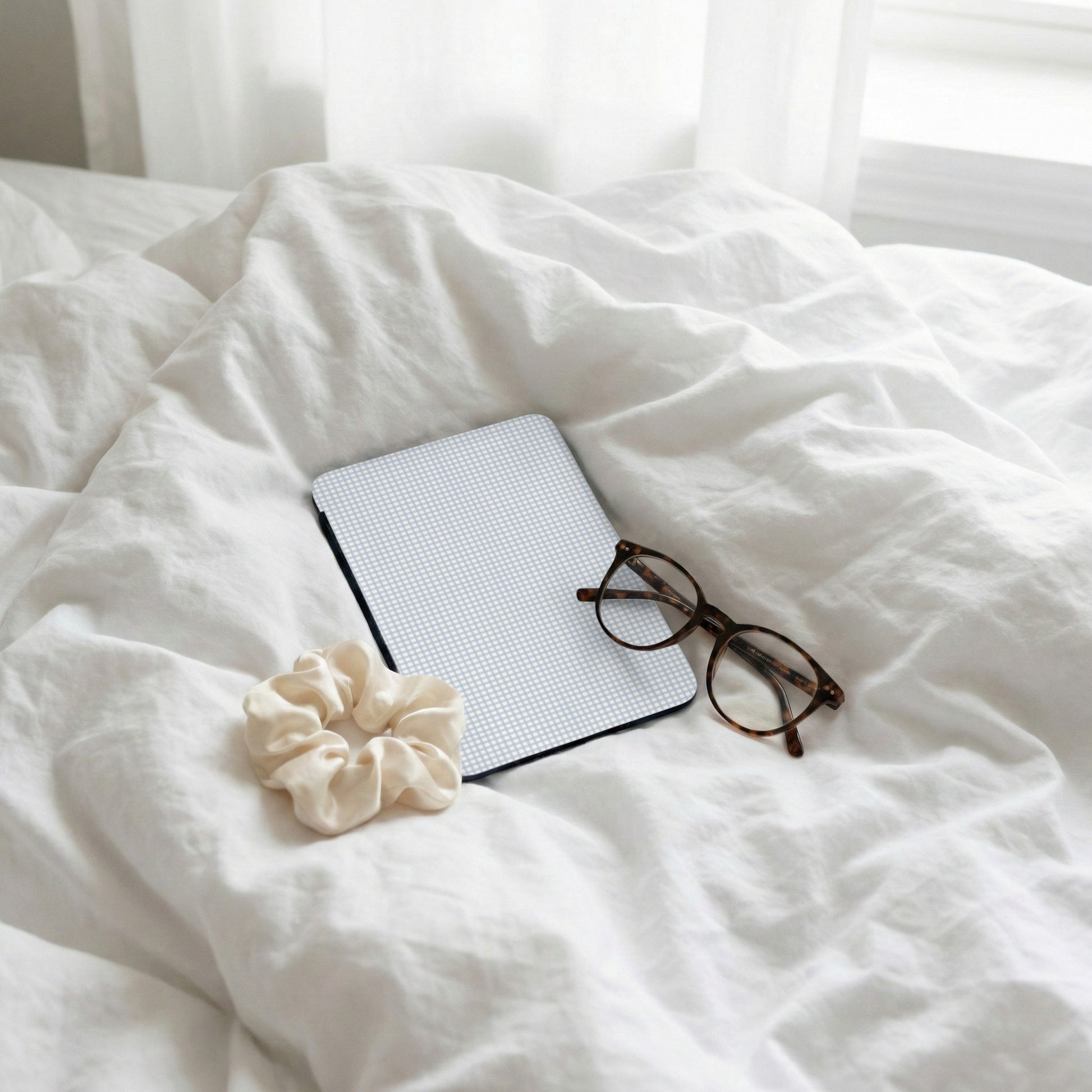 Sleek Tablet With Glasses And Scrunchie on White Bed Display