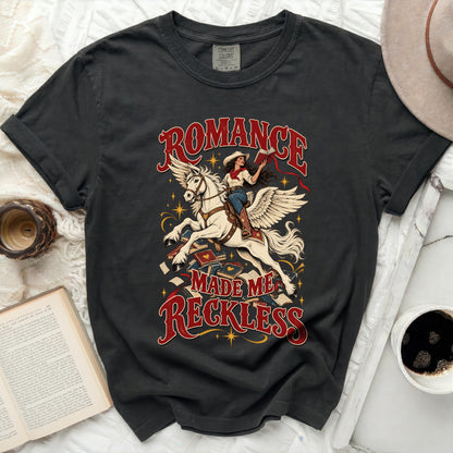 Dark t-shirt with "Romance Made Me Reckless" text and winged horse graphic.