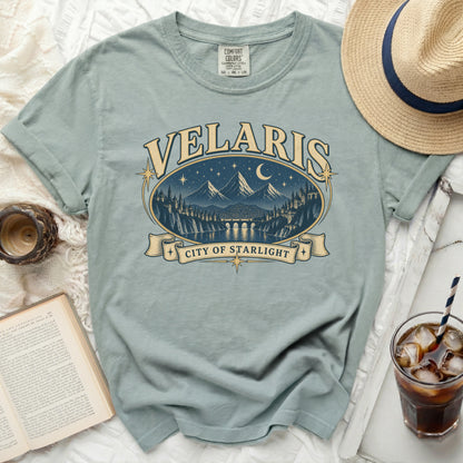 Light blue t-shirt with "Velaris City of Starlight" graphic featuring mountains and a city.