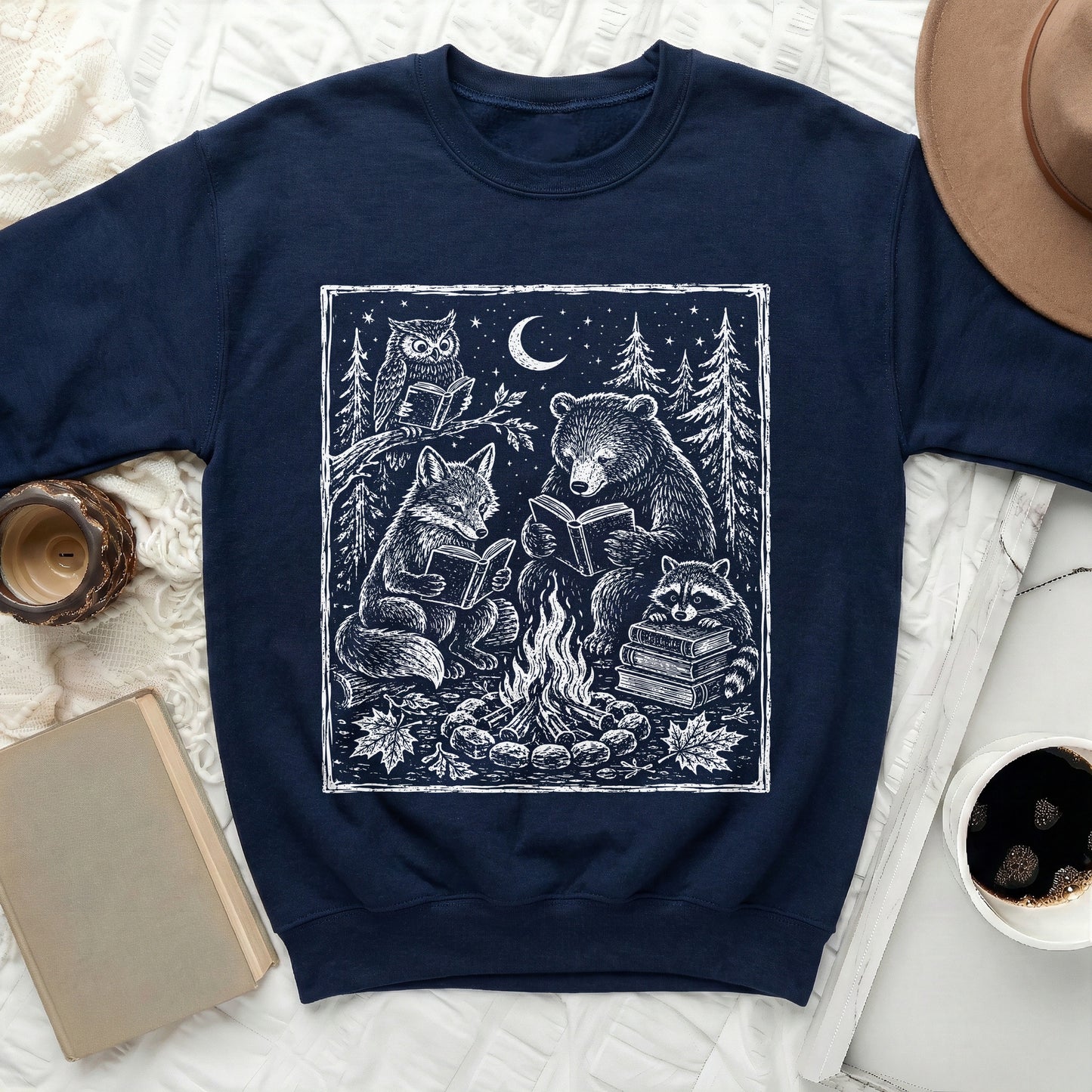 Navy sweatshirt with white linework art of animals reading by a campfire.