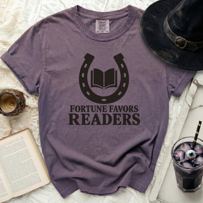 Purple t-shirt with a horseshoe and open book graphic and text: "FORTUNE FAVORS READERS".