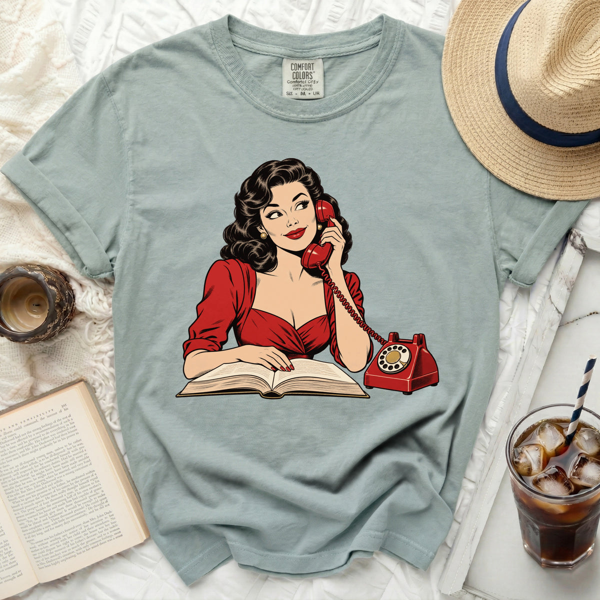 Retro woman with dark hair on phone, reading book with red telephone.