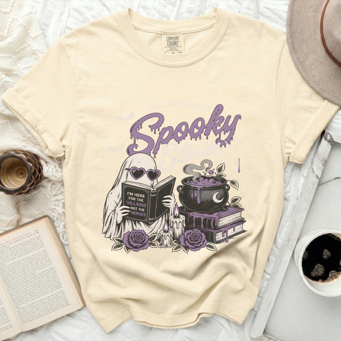 Cream comfort colors t-shirt with ghost reading book, cauldron, and spooky text.