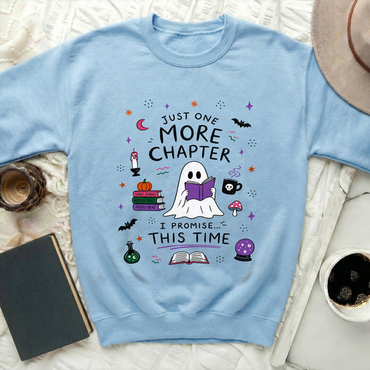 Light blue sweatshirt with a cartoon ghost reading a book and text.