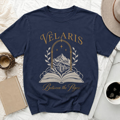 Navy t-shirt with "Velaris Between the Pages" text and an open book illustration.