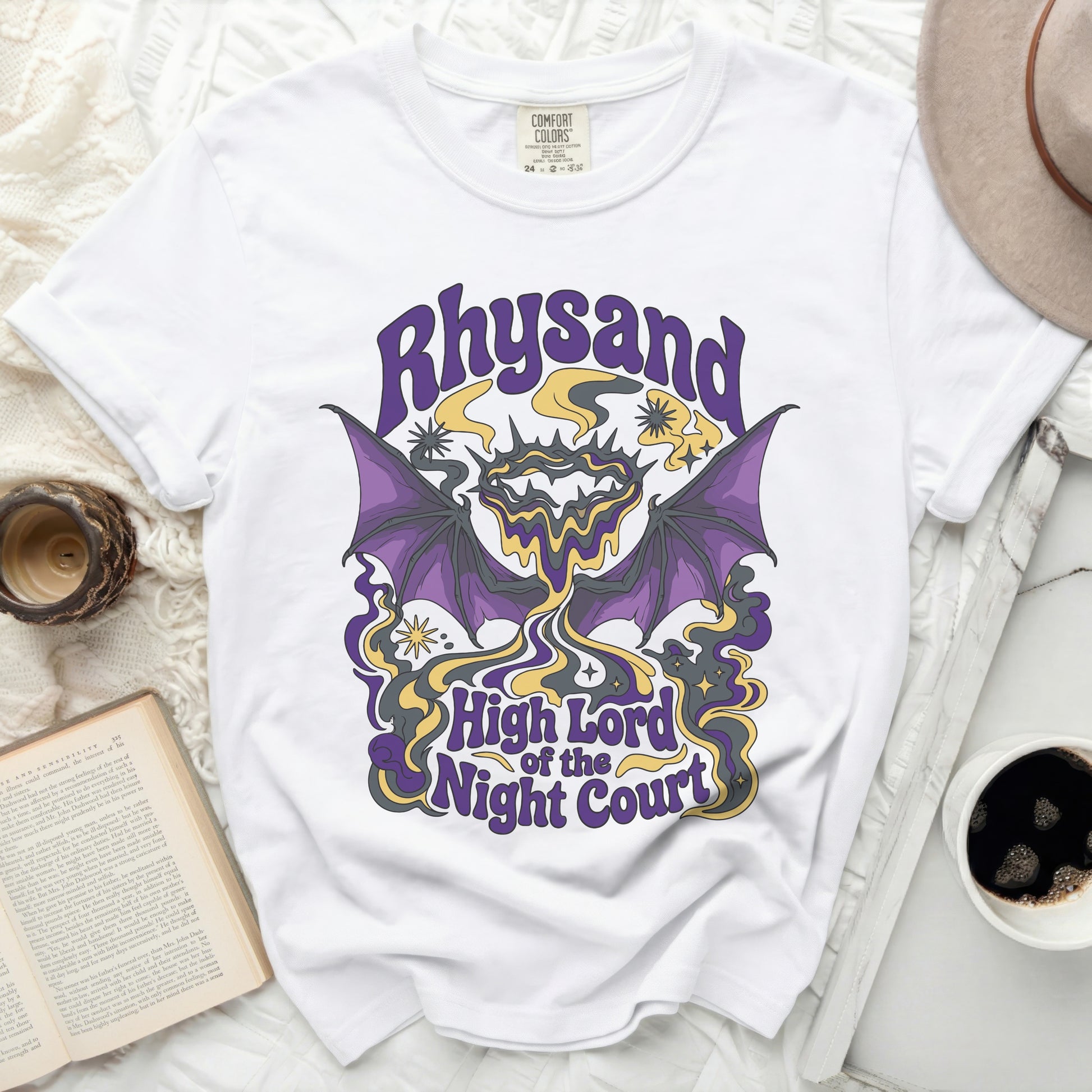 White t-shirt with purple, yellow, and gray graphic of Rhysand, High Lord of the Night Court.