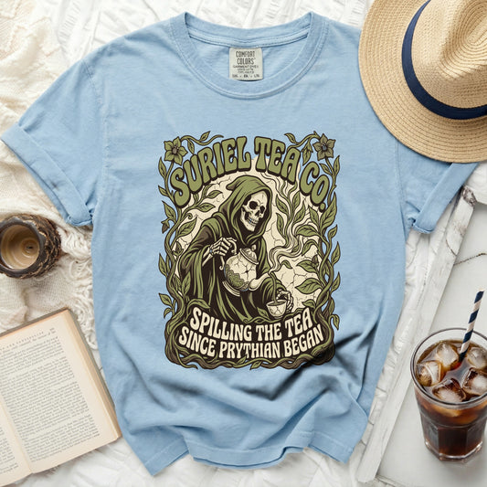 Skeleton pouring tea with text "SURIEL TEA CO SPILLING THE TEA SINCE PRYTHIAN BEGAN".