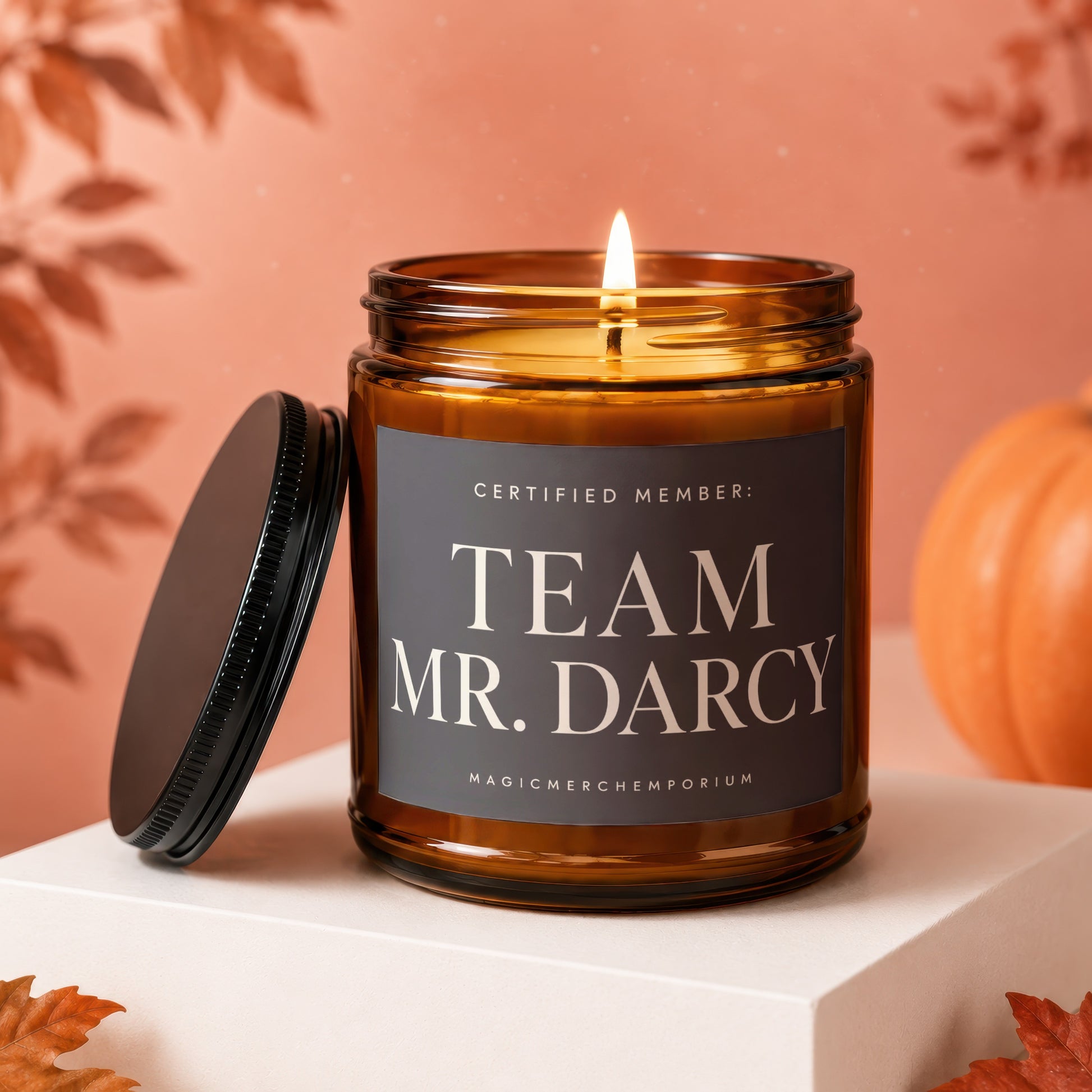 Amber glass candle with black lid, says "Team Mr. Darcy" on label.