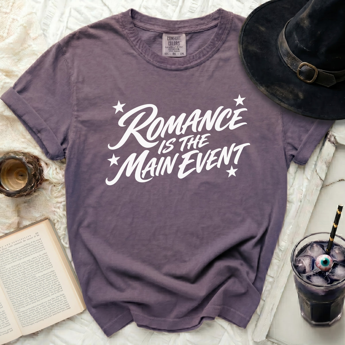 Purple t-shirt with white text "Romance Is The Main Event".