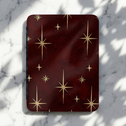 Dark red rectangular object with gold star pattern resting on a marble surface.