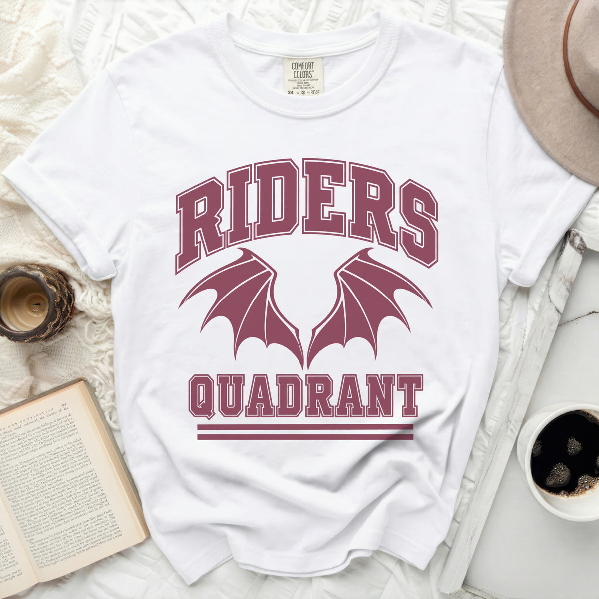 White t-shirt with maroon "RIDERS QUADRANT" text and winged emblem.