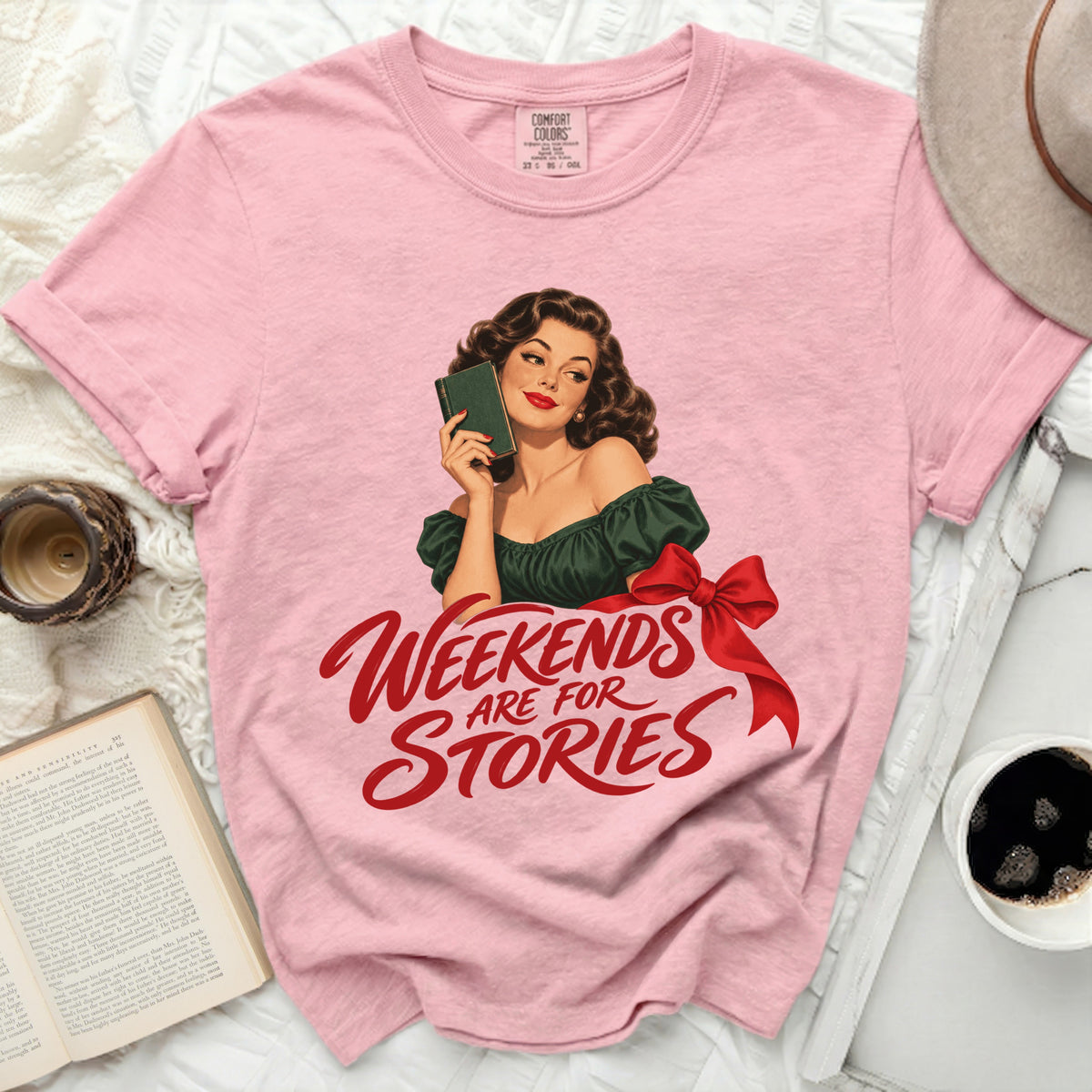 Pink t-shirt with retro woman holding book and text "Weekends Are For Stories".