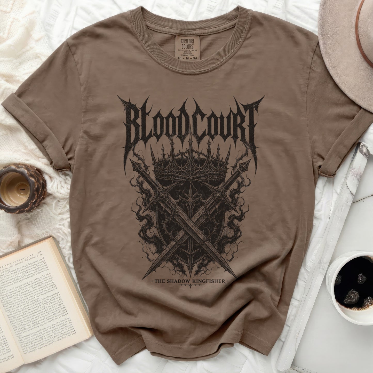 Brown t-shirt with "Blood Court" text, crown, and crossed swords graphic.