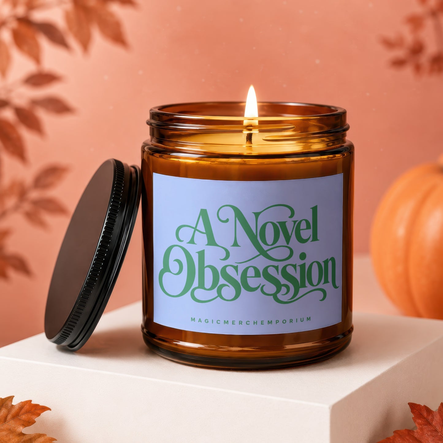 Lit amber glass candle with purple label reading "A Novel Obsession"